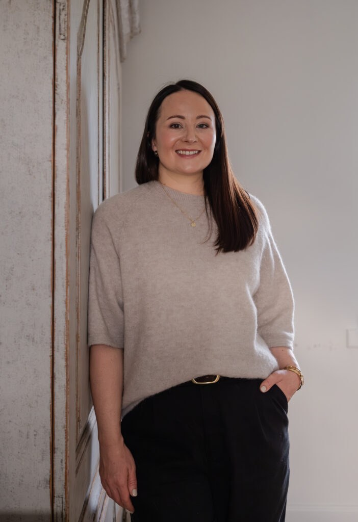 female designer leaning against cabinet