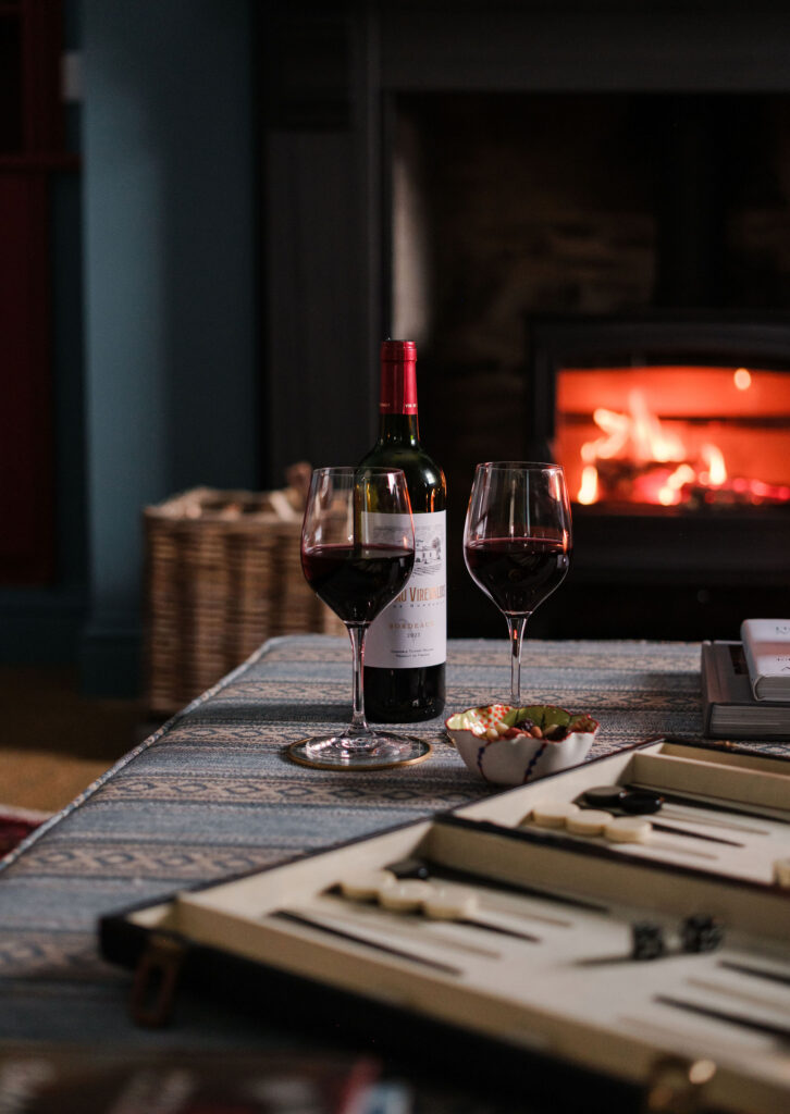 Interior photography of the lounge with wine and games The Schoolhouse, Straloch Estate, Perthshire