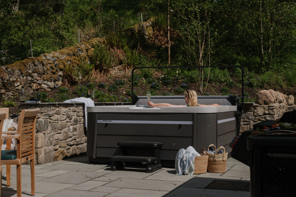 Woman In the hot tub at The Schoolhouse, Straloch Estate, Perthshire